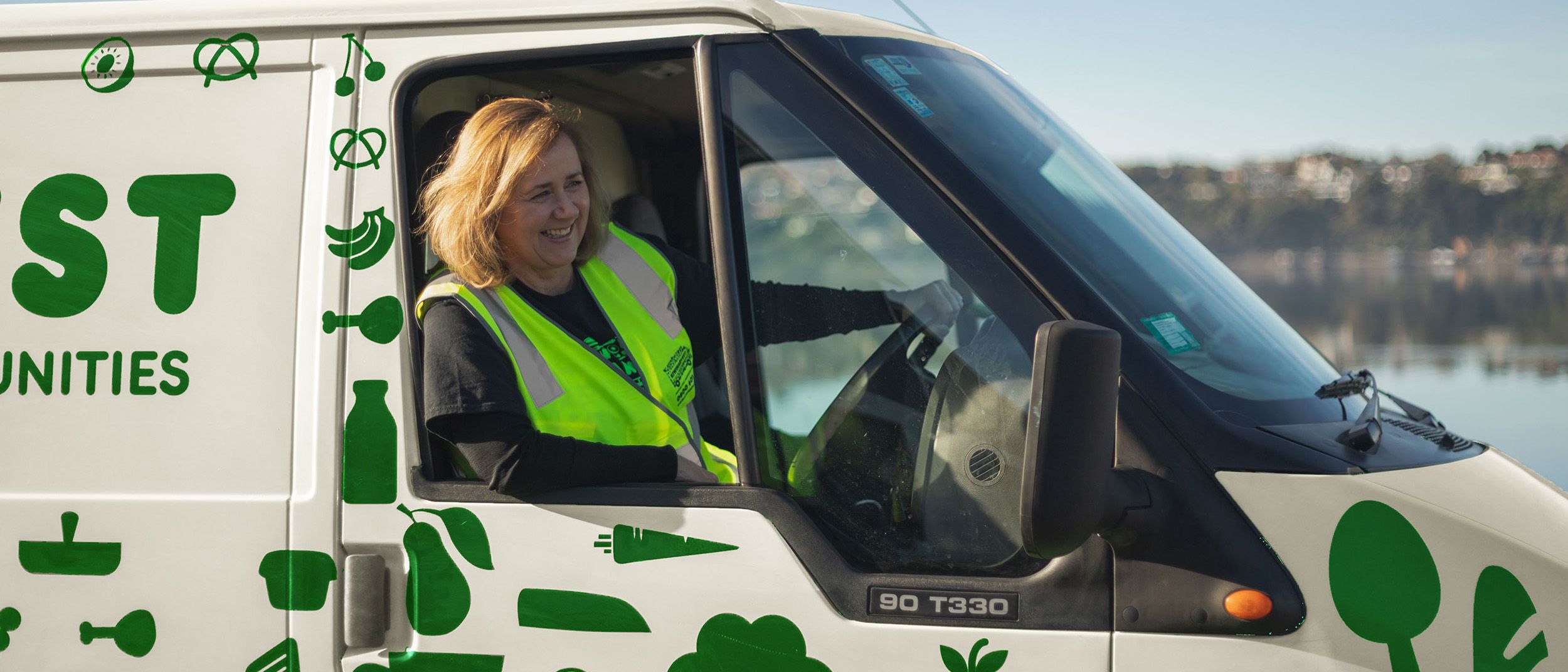 Lady in vest driving the KiwiHarvest van